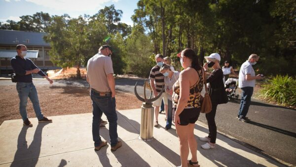 People learning about the Collins Sundial. Image Credit: Matt Woods